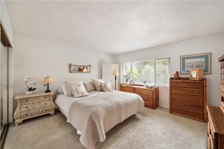 Spacious Primary Bedroom with Mirrored Closet with Custom Organizers and Dual Pane Windows