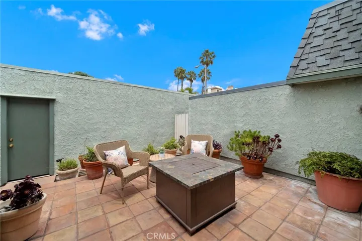 Courtyard-style patio with paver decking, direct access to 2-car garage