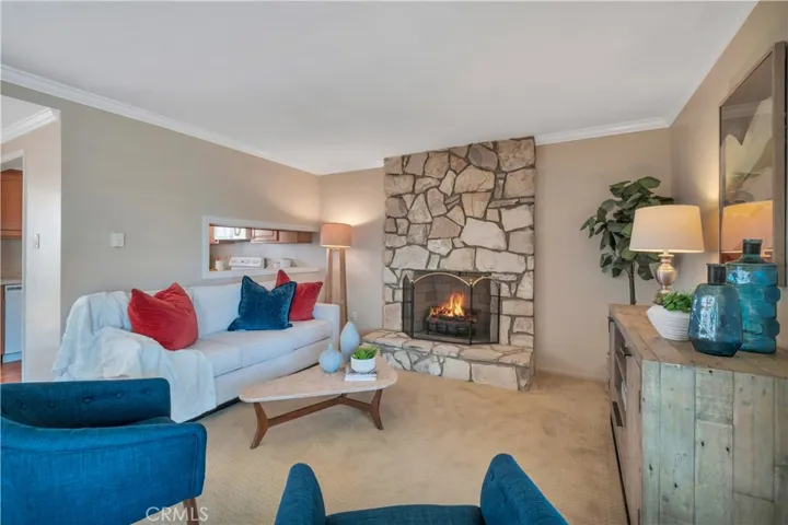 Living room, fireplace and pass through window from kitchen