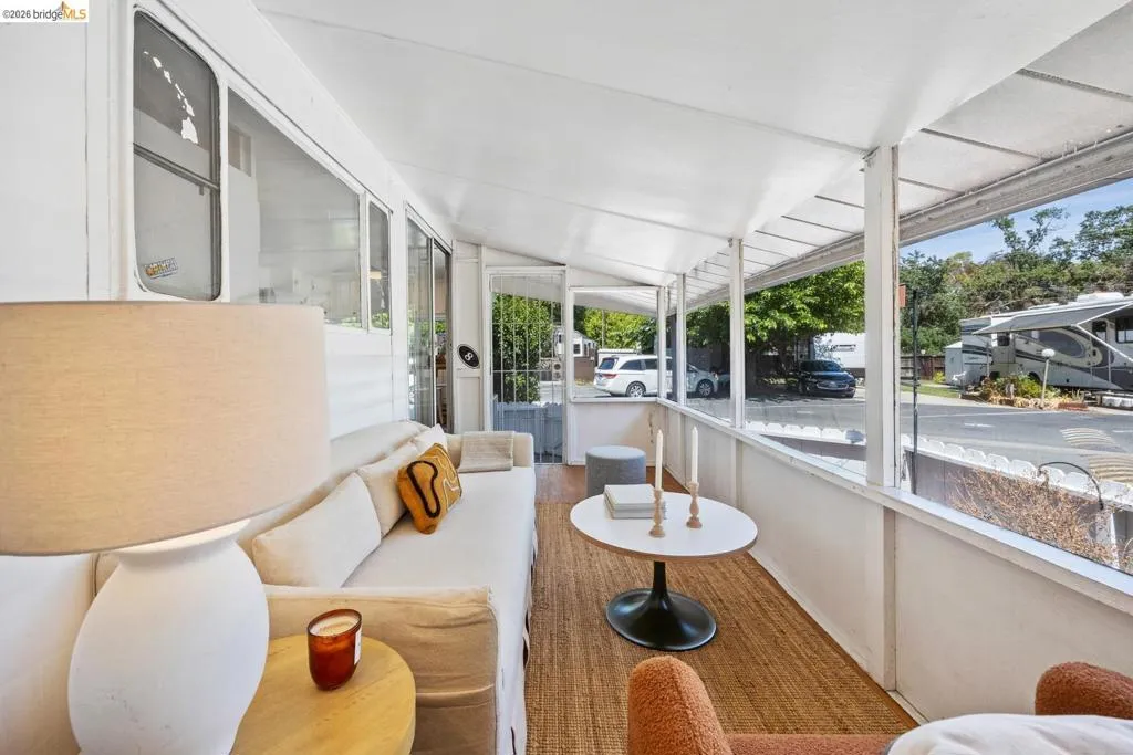 Enclosed porch with wood-finish flooring and a white paneled ceiling