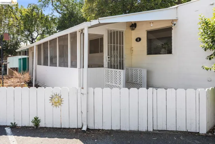 White picket fence entry with a sunburst accent