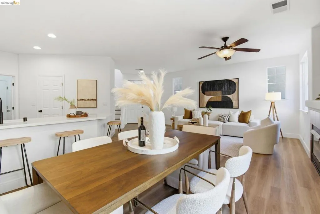 Open-concept living space featuring wood-finish flooring, recessed lighting, and a ceiling fan