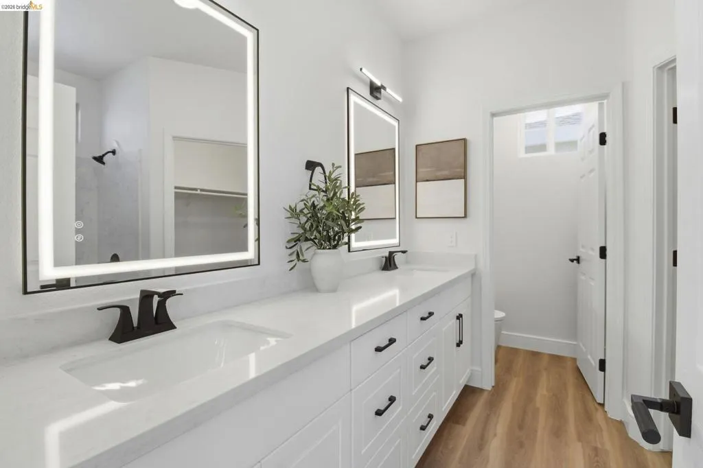 Double vanity featuring white cabinetry, quartz countertop, and undermount sinks