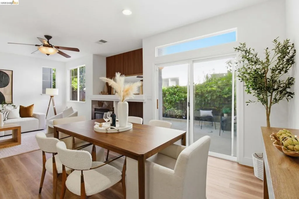 Open-concept living area with wood-finish flooring, recessed lighting, and a ceiling fan