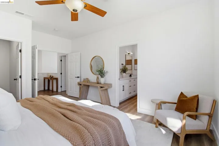 Bright room featuring wood-finish flooring and a ceiling fan