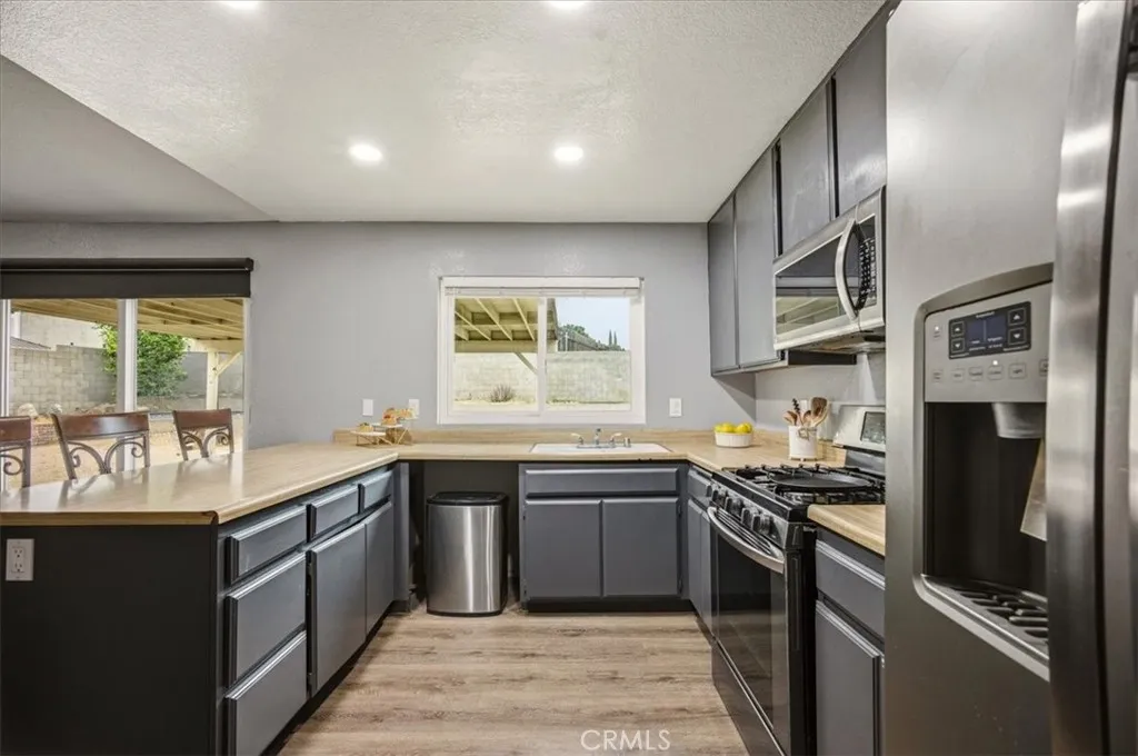 Kitchen has an eat-in bar counter and is open the dining area.