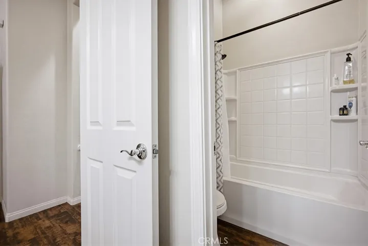 Hallway bathroom with shower in tub