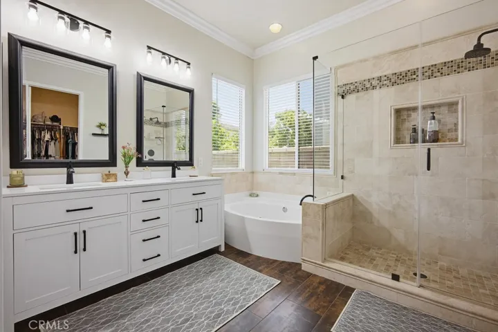Ensuite primary bathroom with dual vanitees