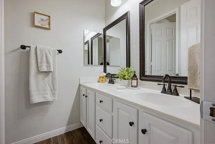 Hallway bathroom with dual vanities