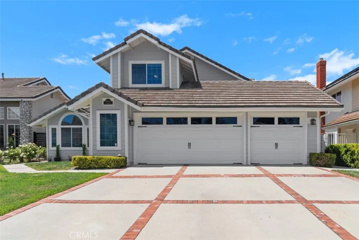 New siding and paint, fresh and bright. 3-car garage with the car driveway and fourth space behind the single garage door, opens to the back with another garage door in back.