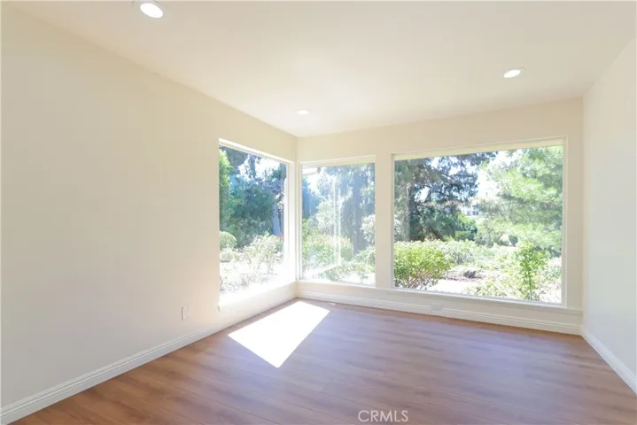 Floor to ceiling views of gardens and course in dining room