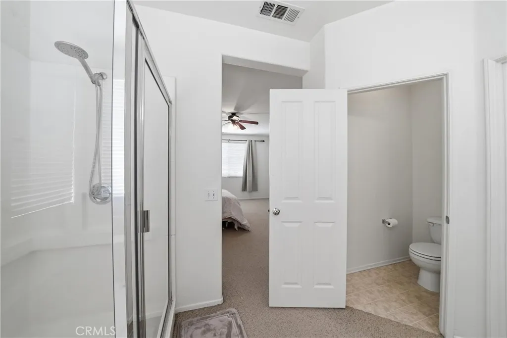 primary bathroom with 1 of the walk in closets in bathroom