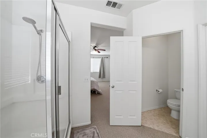 primary bathroom with 1 of the walk in closets in bathroom