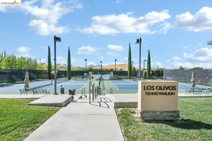 Tennis pavilion entrance featuring a stone-clad sign