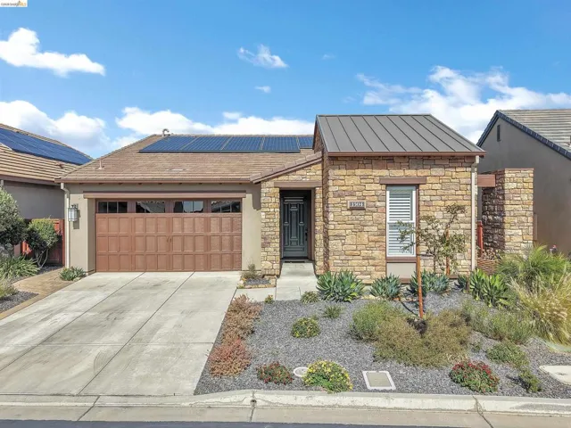 Stone veneer facade featuring a metal accent roof over the entry