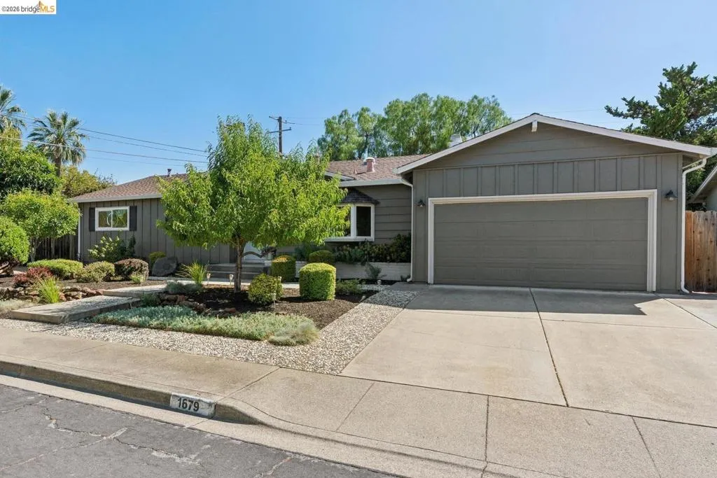 Exterior featuring a two-car garage, concrete driveway, and board and batten siding