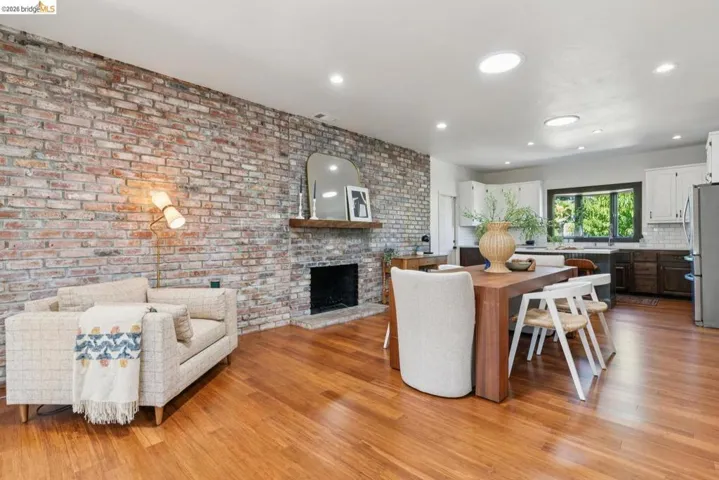 Brick accent wall with a wood-mantel fireplace