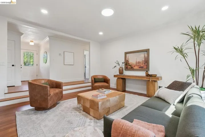 Living area featuring recessed lighting, a skylight, and wood-finish flooring