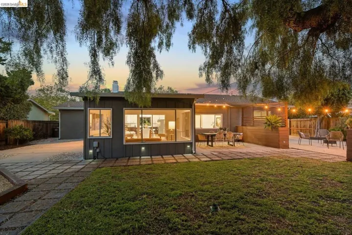 Exterior featuring modern grey siding and large window panes