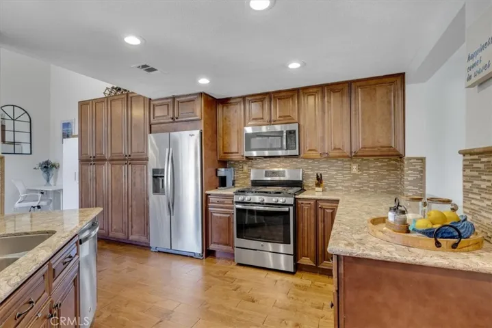 The kitchen was expanded into the former family/nook area and includes additional storage and pantry space!