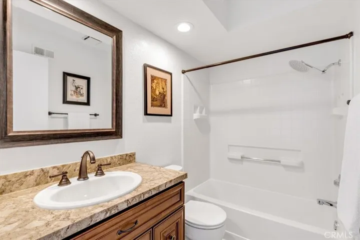 The third full bath is located upstairs in the loft area.