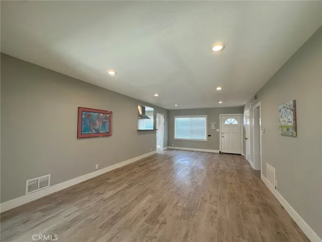 Living Room- recessed light, LVP flooring, newer baseboard