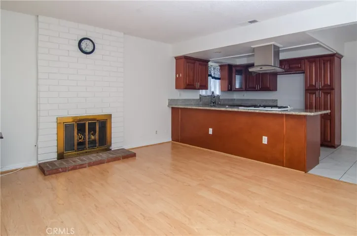 Fireplace - flames digitally staged - open & updated kitchen