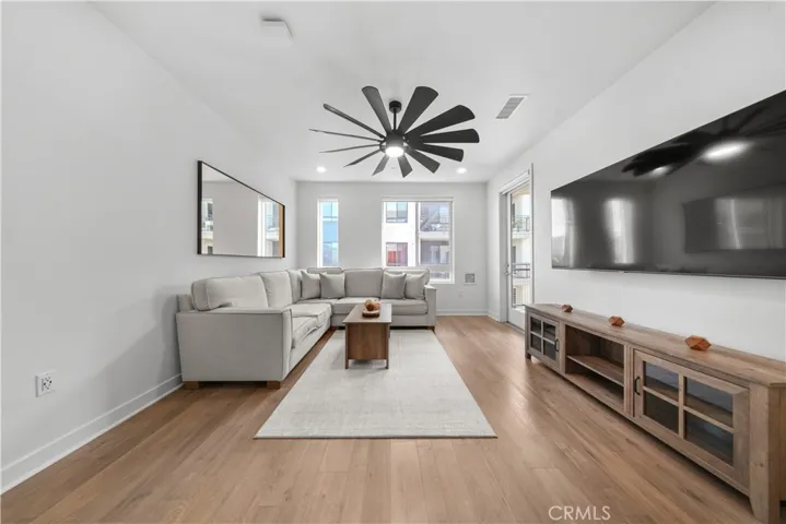 To the rear is the family room which has a ceiling fan with light and remote window treatments