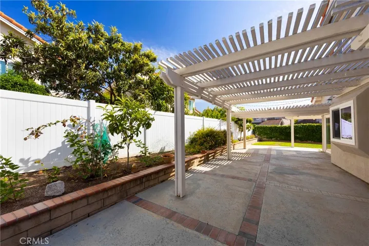 Expansive backyard outlined by fruit trees and well maintained landscaping.