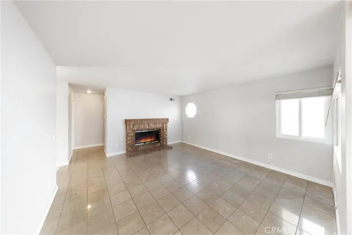 Cozy family room with enchanting brick fireplace.