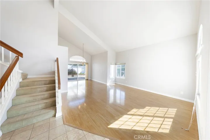 Formal entrance to the home showcasing high ceilings, ample natural lighting, and open concept floorplan.