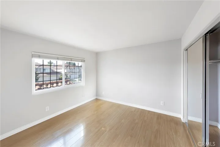 Additional secondary bedroom with accompanied lengthy closet and inviting natural lighting.