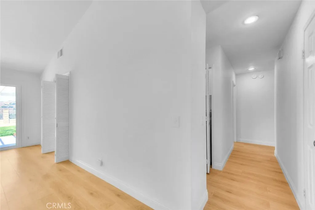Hallway from the family room to 3 bedrooms and laundry closet.
