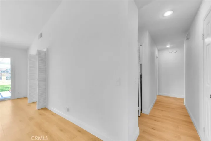 Hallway from the family room to 3 bedrooms and laundry closet.
