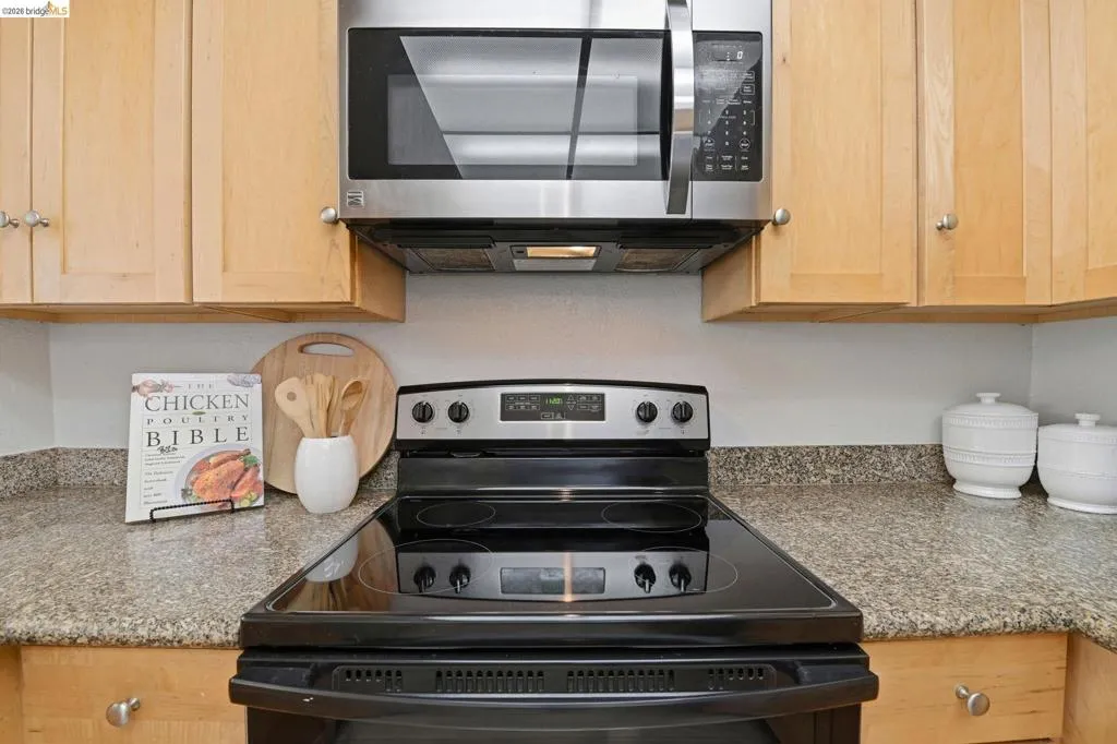 Black electric range with a stainless steel microwave hood