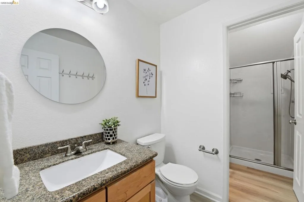 Bathroom featuring a vanity with a granite countertop, undermount sink, and brushed nickel fixtures