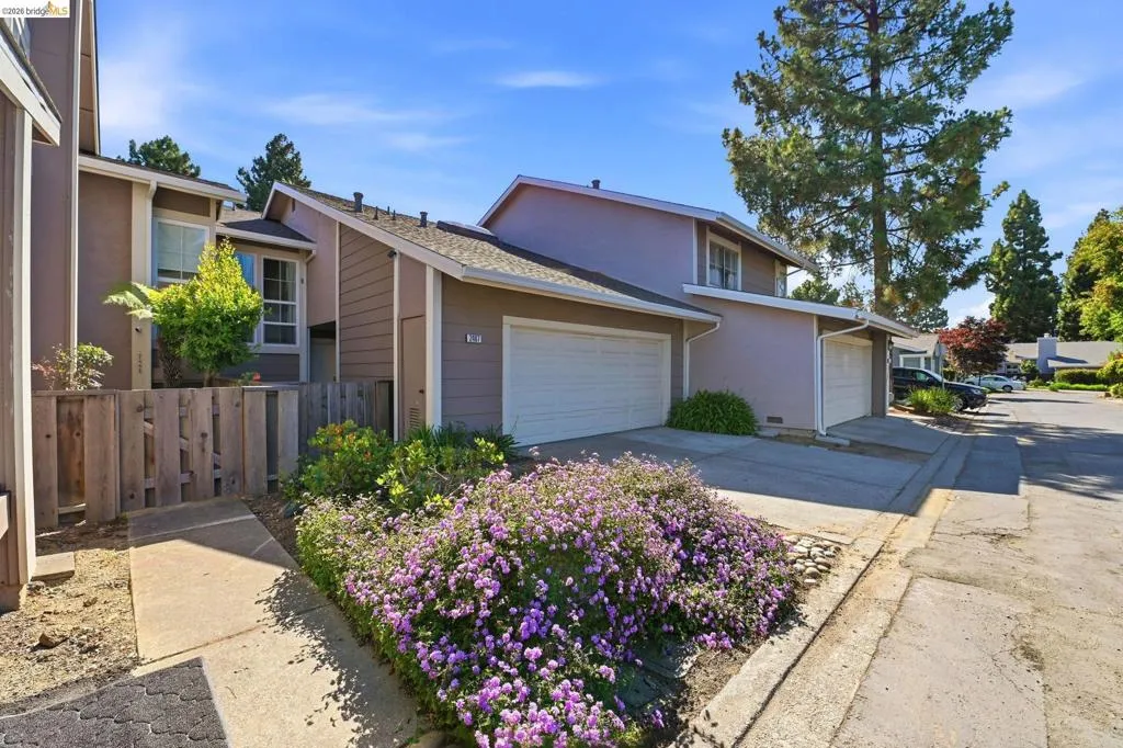 Contemporary multi-story residence featuring a two-car garage and a paved driveway