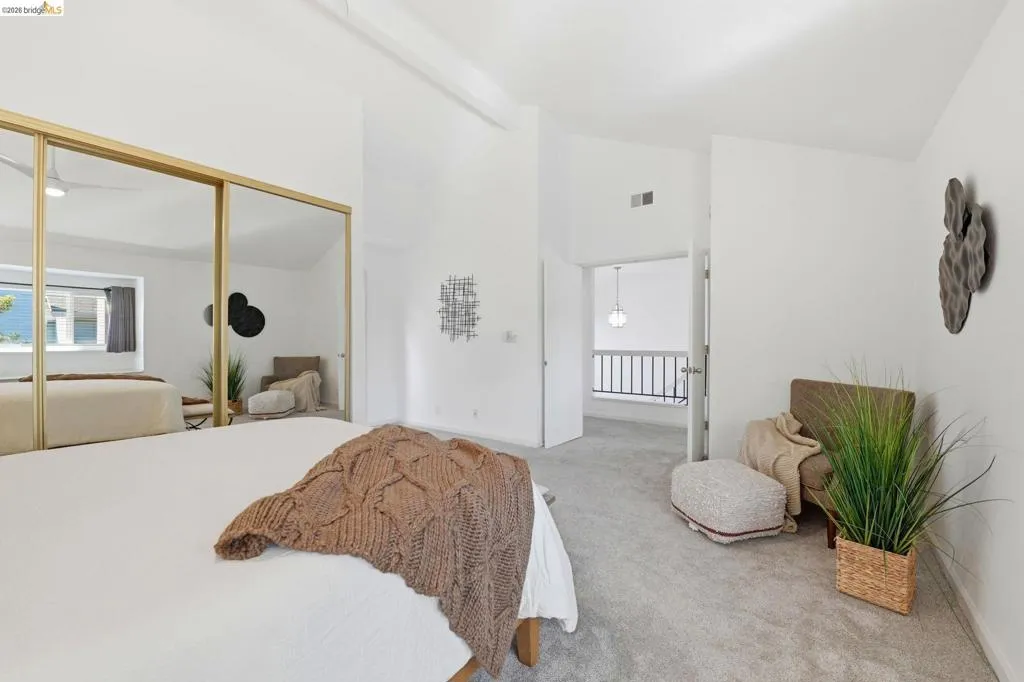 Room featuring vaulted ceilings and light gray carpeting