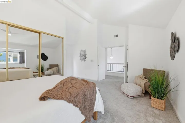 Room featuring vaulted ceilings and light gray carpeting