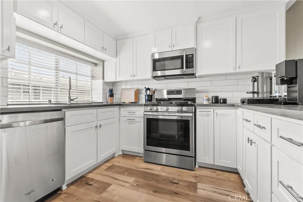 Modern updated kitchen, pullouts, storage, stainless steel appliances, quartz counters, recessed lights, new cabinets, very efficient, light and bright