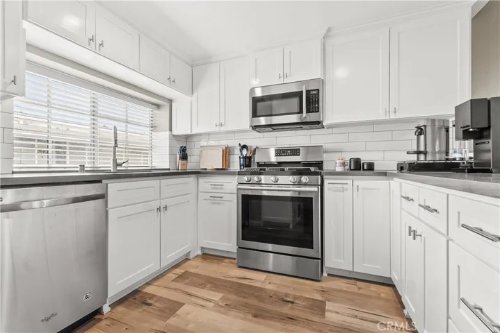 Modern updated kitchen, pullouts, storage, stainless steel appliances, quartz counters, recessed lights, new cabinets, very efficient, light and bright