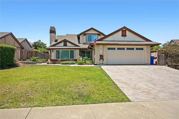 Straight on full view of property with paver driveway on display.