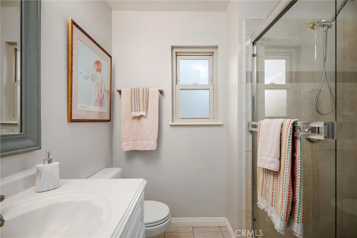 Downstairs en suite bathroom glass shower doors.