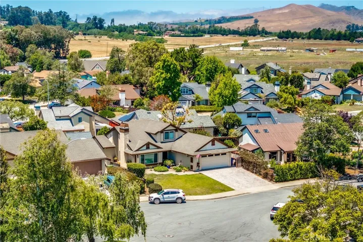 Aerial view of house from cul de sac showing proximity to open space.