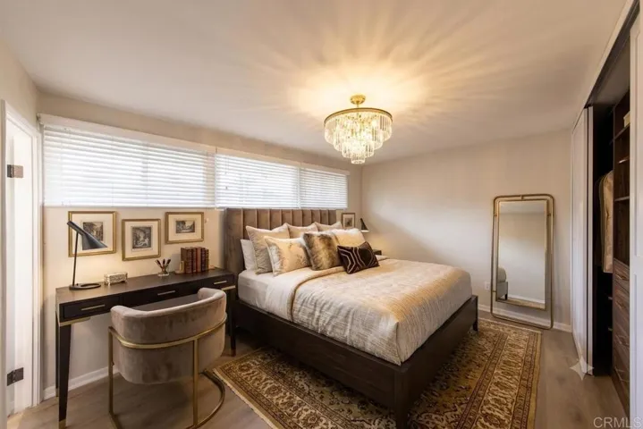 Bedroom with new windows, flooring, closet and finishes.