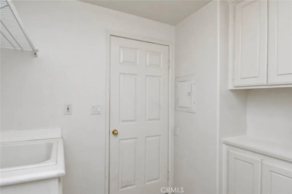 Laundry room with extra storage space and a one year old water heater.