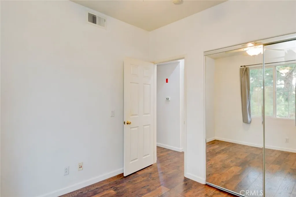 The second bedroom with mirrored closet doors.