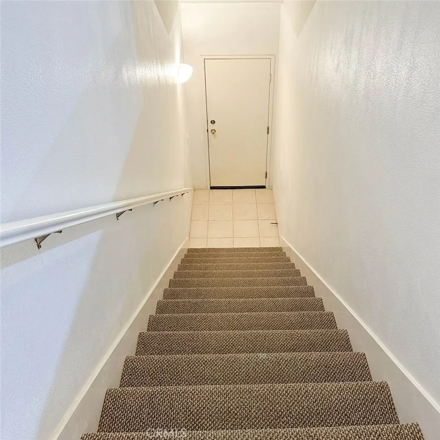 The staircases lead to the attached garage.