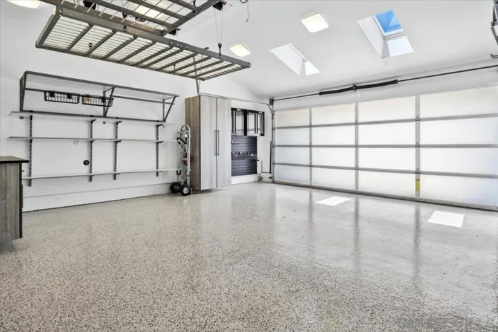 All storage in the garage will convey with the house.  The racks on the ceiling are powered and lower at the touch of a button.