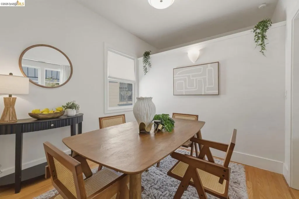 Dining area featuring wood-finish flooring, white walls, and a recessed window